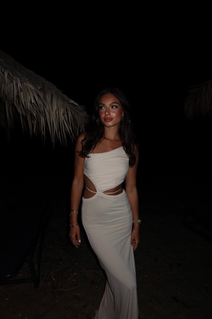 Best-selling asymmetrical maxi dress with ruching and waist tie detail. Fitted at the bust and hips, with a slightly loose body of the skirt. Made from lightweight, non-stretch fabric. Note: Not bra-friendly.