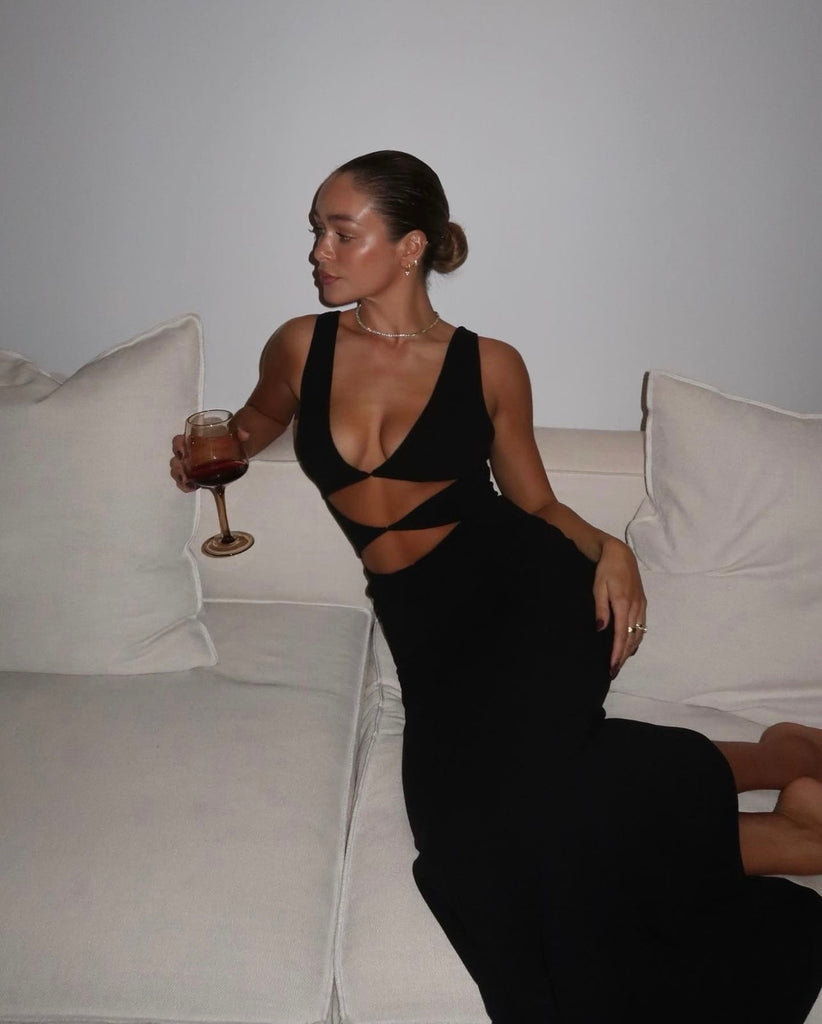 The 'Elise Gown' crafted from figure-hugging stretch crepe, featuring edgy diamond-shaped cutouts at the front."